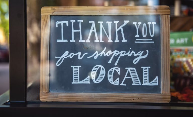 A sign thanking you for shopping locally. AI can help small businesses reach a wider customer base