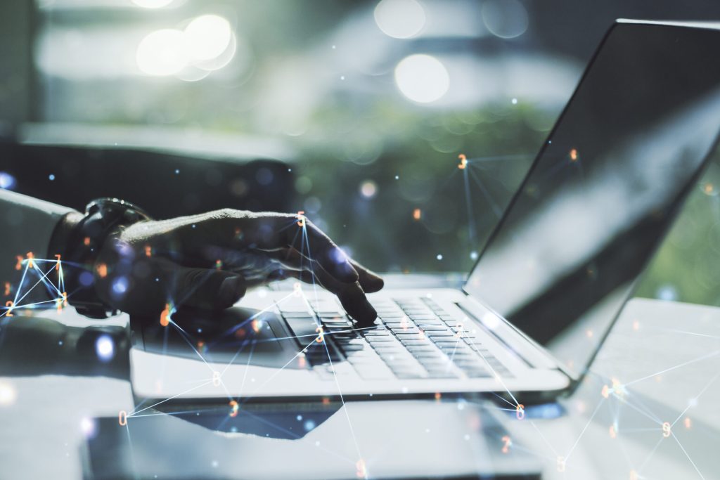 Creative concept of wireless technology and hands typing on laptop on background. Big data and database concept. Multiexposure